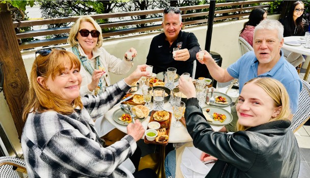 A group raising glasses over a shared meal