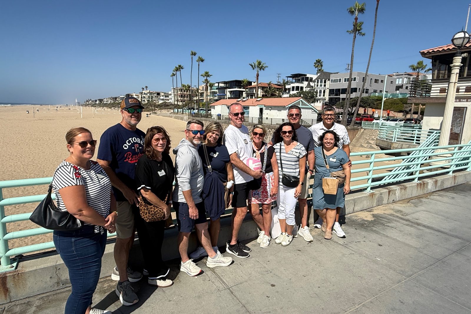 A tour group on the Manhattan Beach Pier with the beach behind them