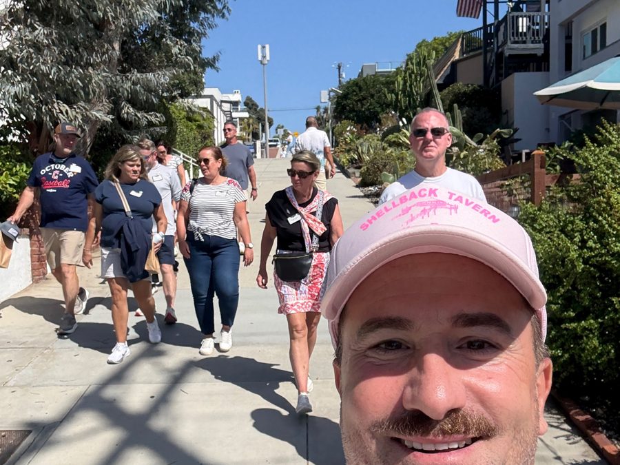 Brian leading guests down a sunny Manhattan Beach street