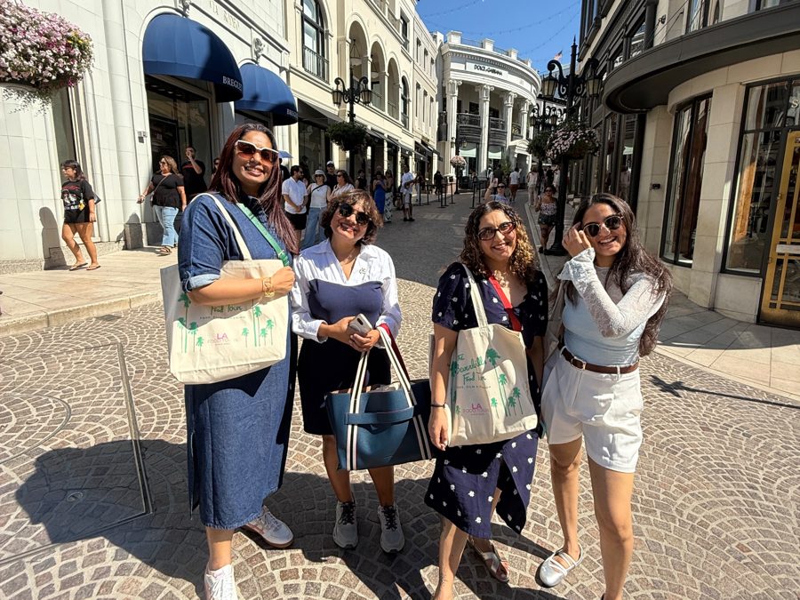 Guests with LA Food Tours tote bags on the cobblestones of Two Rodeo